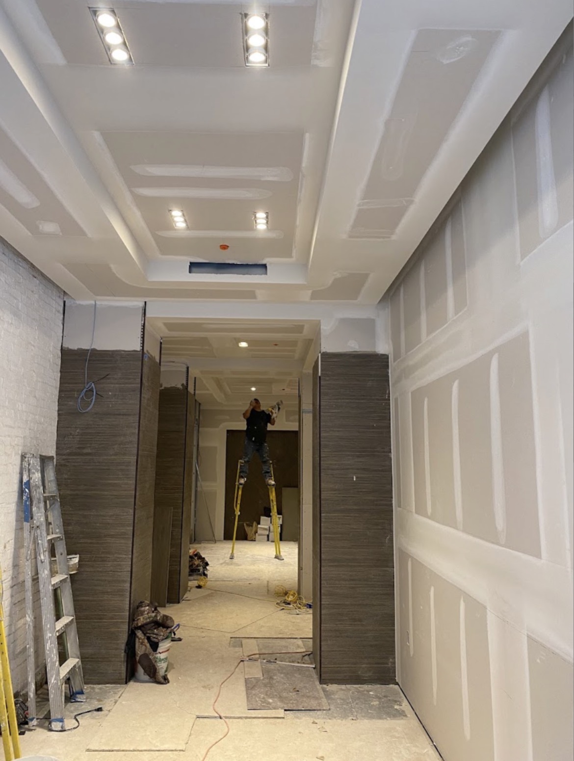 Tray ceiling and hallway drywall with recessed lighting